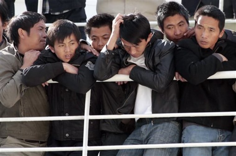 Chinese citizens wait aboard the \"Palermo Grimaldi\" ferry at the harbor in Valletta, Malta, Saturday, Feb. 26, 2011, after being evacuated from Benghazi, Libya. Tens of thousands of foreigners have been fleeing Libya this week. Turkish and Chinese workers climbed aboard ships by the thousands, Europeans mostly boarded evacuation flights and North Africans have been heading to Libya's borders with Egypt and Tunisia in overcrowded vans. (AP Photo/Gregorio Borgia)